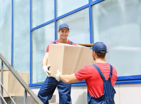 Professional house removalists packing boxes in a Ruislip home